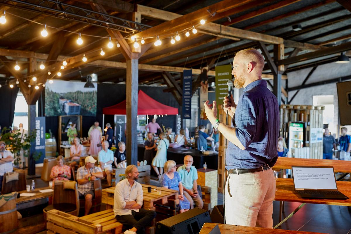 Mand står og taler foran publikun